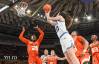 Maddy Siegrist, right, wearing white, shoots over a Miami defender.