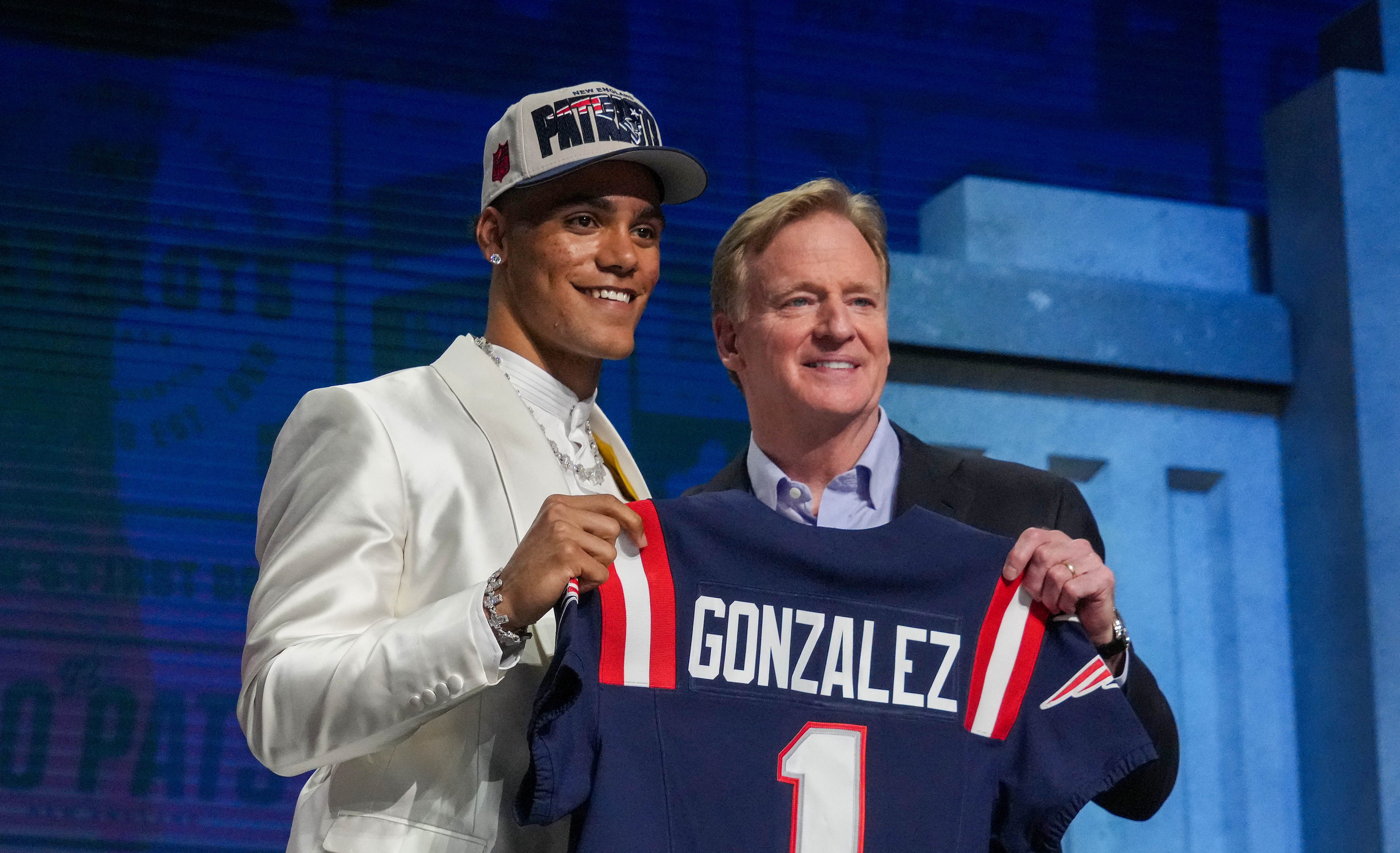 Christian Gonzalez poses with Roger Goodell after being drafted by the Patriots, April 2023