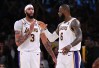 Anthony Davis and LeBron James shake hands on the court in celebration of a basket.