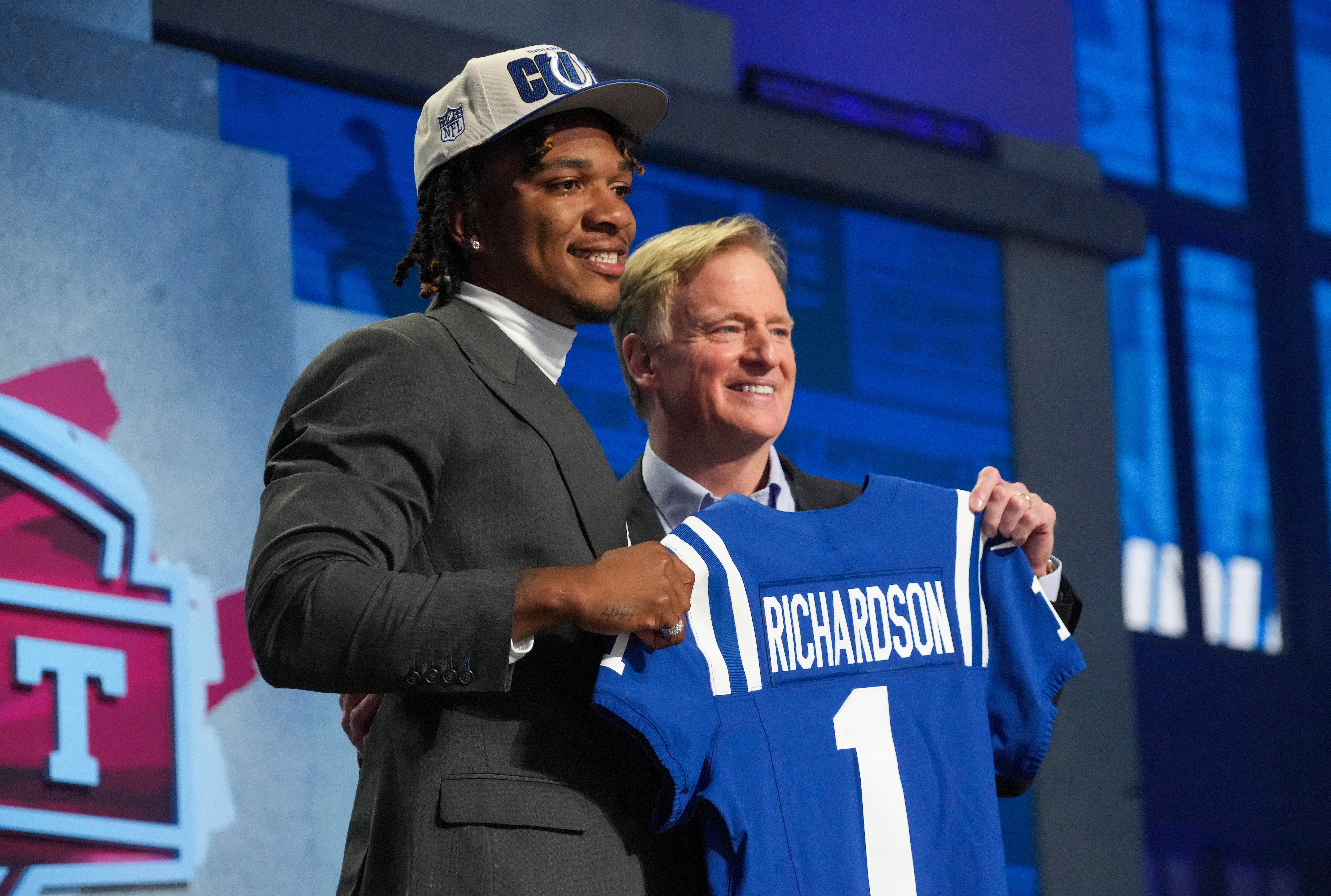 Anthony Richardson posing next to Roger Goodell with a jersey in hand after being drafted by the Colts.