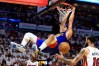 Denver Nuggets forward Aaron Gordon hanging on the rim after a dunk against the Miami Heat in the NBA Finals.