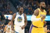 Draymond Green celebrates as LeBron James runs up the floor.