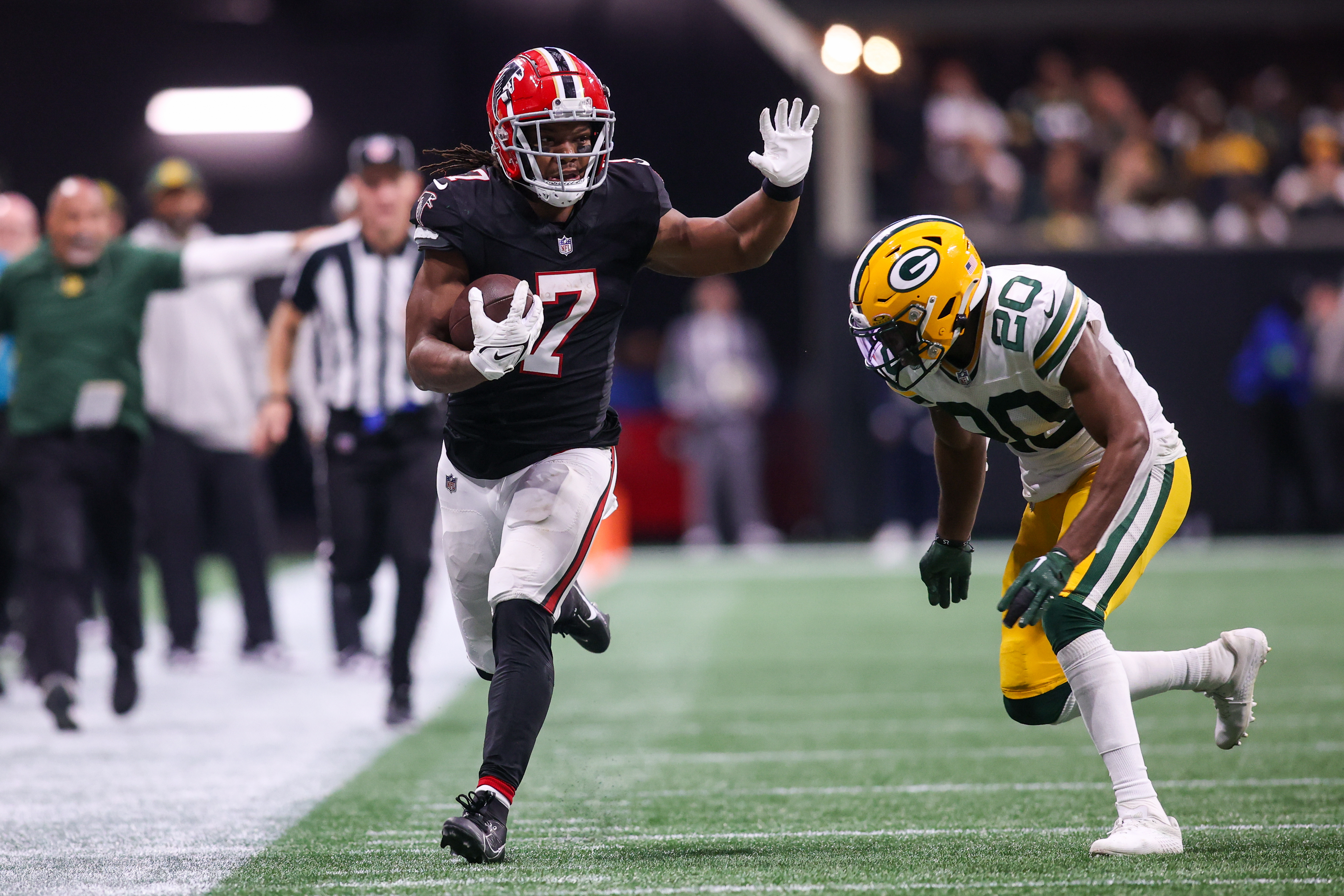 Sep 17, 2023; Atlanta, Georgia, USA; Atlanta Falcons running back Bijan Robinson (7) is pushed out of bounds by Green Bay Packers safety Rudy Ford (20) in the second half at Mercedes-Benz Stadium.
