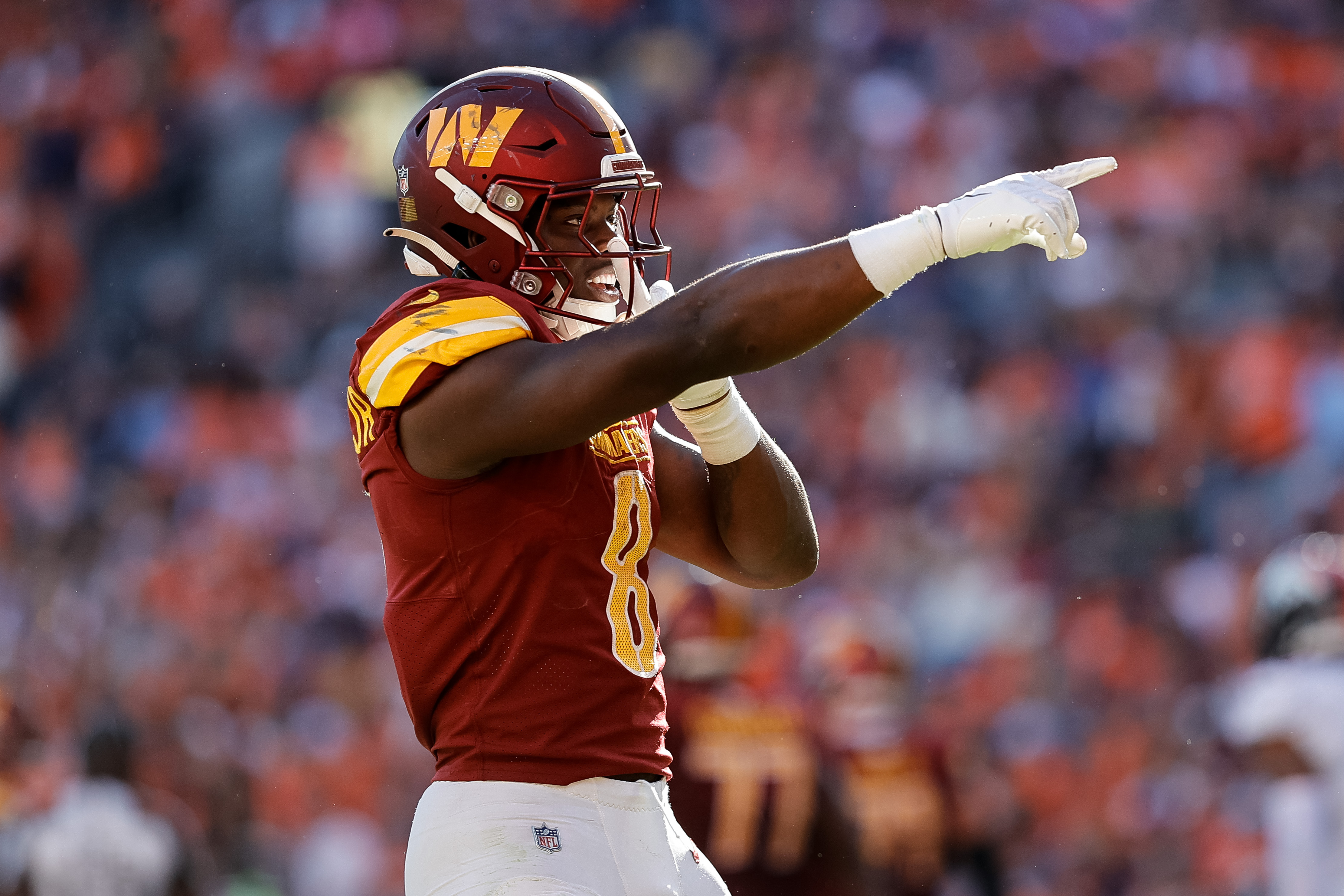 Sep 17, 2023; Denver, Colorado, USA; Washington Commanders running back Brian Robinson Jr. (8) reacts after scoring a touchdown in the fourth quarter against the Denver Broncos at Empower Field at Mile High.
