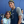 UConn Huskies basketball forward Aaliyah Edwards, wearing wearing a Huskies warmup jersey and gray shirt, smiles and poses for a picture with a young fan named Ari