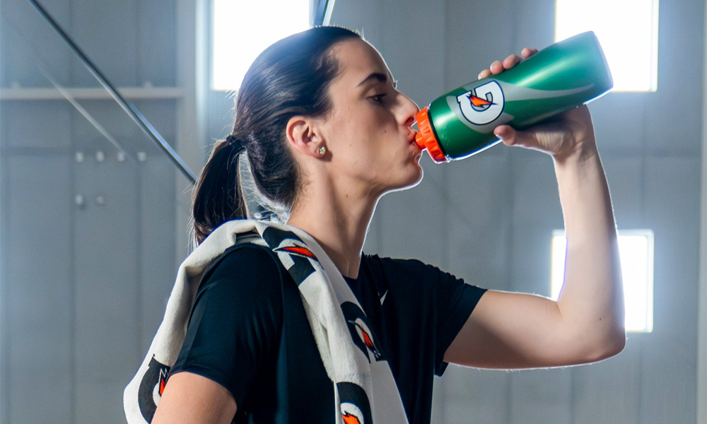 Iowa Hawkeyes guard Caitlin Clark drinking from a Gatorade bottle as part of new NIL deal