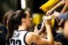 Iowa guard Caitlin Clark (22) signs autographs for fans after a NCAA college women's basketball game at Carver-Hawkeye Arena