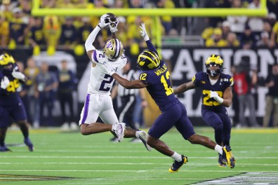 Ja'Lynn Polk #2 of the Washington Huskies catches a pass against Josh Wallace #12 of the Michigan Wolverines in the first half during the 2024 CFP National Championship game at NRG Stadium on January 08, 2024 in Houston, Texas
