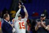 Kansas City Chiefs quarterback Patrick Mahomes (15) celebrates with the Lamar Hunt Trophy while speaking with CBS broadcaster Jim Nance during the trophy presentation after the Chiefs' game against the Baltimore Ravens in the AFC Championship football game