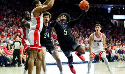 Washington Huskies guard Sahvir Wheeler (5) shoots a basket against Arizona Wildcats forward Keshad Johnson (16) during the 1st half at McKale Center.