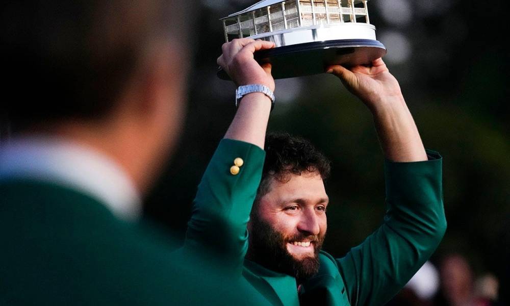 Masters champion Jon Rahm holds up the trophy after the final round of The Masters golf tournament